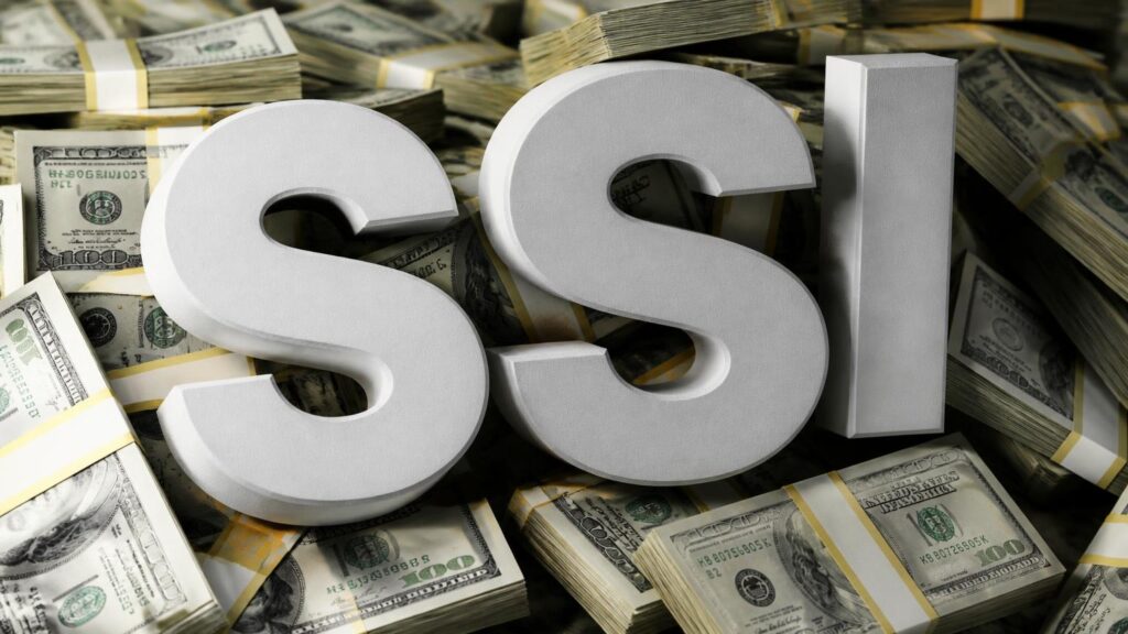 Letras tridimensionales «SSI» colocadas sobre fajos de billetes de 100 dólares apilados.